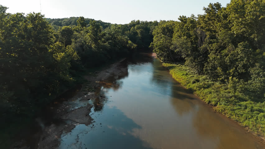 Establishing upstream river channel winding through forest, Bush Creek Bay Lake Eucha, aerial backdrop