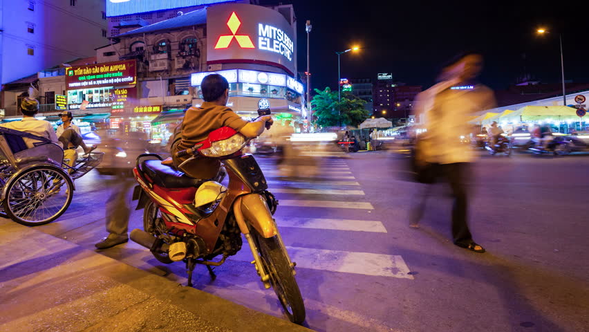 HO CHI MINH CITY - JUNE 8: Panning Timelapse view of vietnamese moto taxi driver