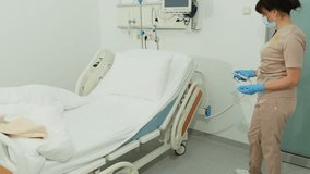 Nurse adjusts hospital bed height with remote control after patient care. Medical worker changes bed level preparing setup for next step - Powered by Shutterstock - Get 15% off with code: PIKWIZARD15