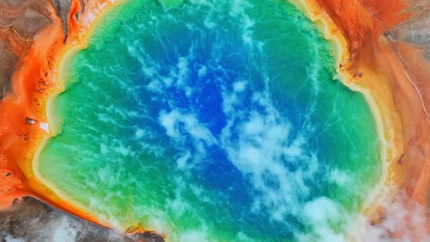Grand Prismatic Springs vibrant rainbow colors Excelsior Geyser Crater Mid Geyser Basin Wyoming Yellowstone National Park aerial drone birdseye view nature landscape morning colorful vibrant upwards
