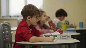 Pupils listening to teacher during lesson in classroom, science education - Powered by Shutterstock - Get 15% off with code: PIKWIZARD15