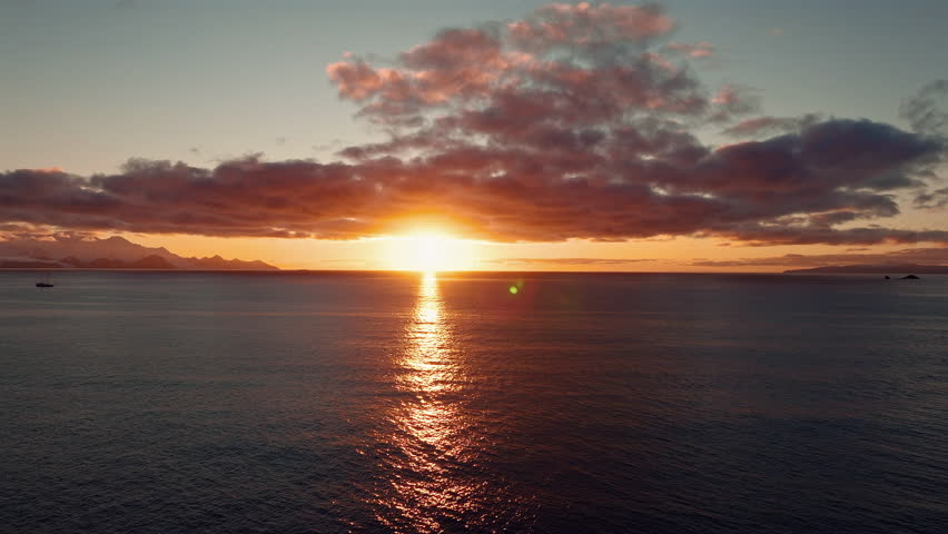 Golden Sunset Over Antarctic Sea with Sailboat Silhouette