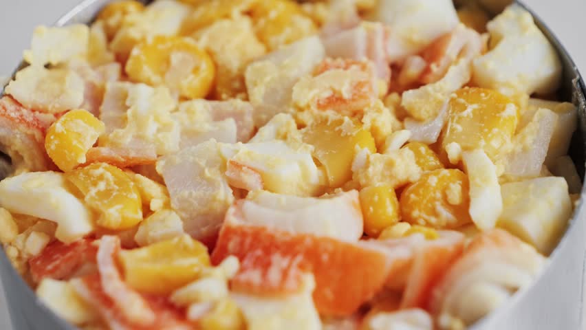 Crabmeat salad with eggs, canned corn, homemade mayonnaise, and ground pepper. High quality 4k footage