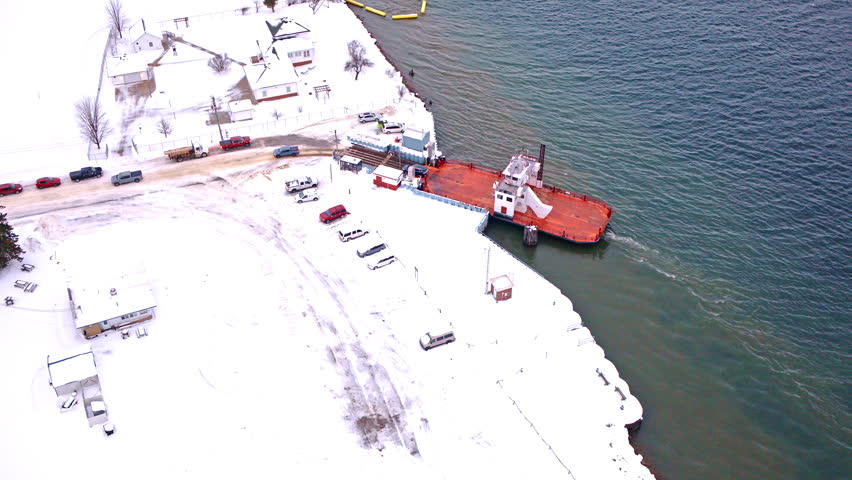 Overhead drone shot of a car ferry moving across the river near Sugar Island, Michigan.