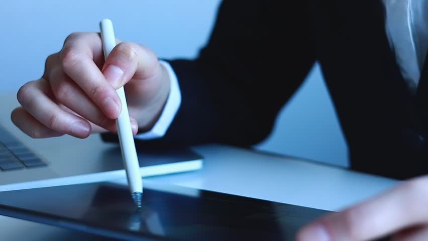 Showcasing a person using a tablet and interacting with digital elements related to technology and artificial intelligence in an office setting.