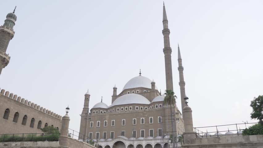 A clear view of the historic Mosque of Muhammad Ali (Alabaster Mosque) at the Saladin Citadel in Cairo, Egypt, showcasing its grand domes and tall minarets.