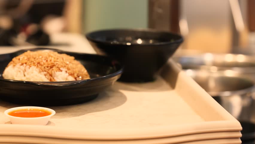 Rice with soy sauce served on plate at food court closeup