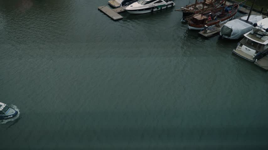 A police boat patrolling the marina, seen through the window of a building, Gdansk, Poland.