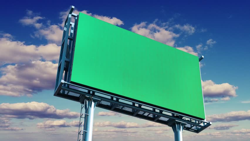 Large billboard with a green screen for advertising on the building wall.
