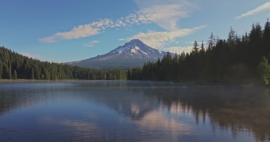 Aerial shot of Trillium Lake in the forest reflecting Mount Hood on the calm surface in Oregon, USA