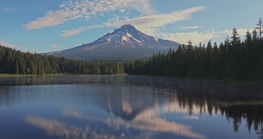 Aerial shot of Trillium Lake in the forest reflecting Mount Hood on the calm surface in Oregon, USA