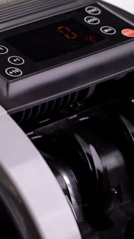 Money counting machine. Currency counting machine counting US money. Slow Motion, vertical video.