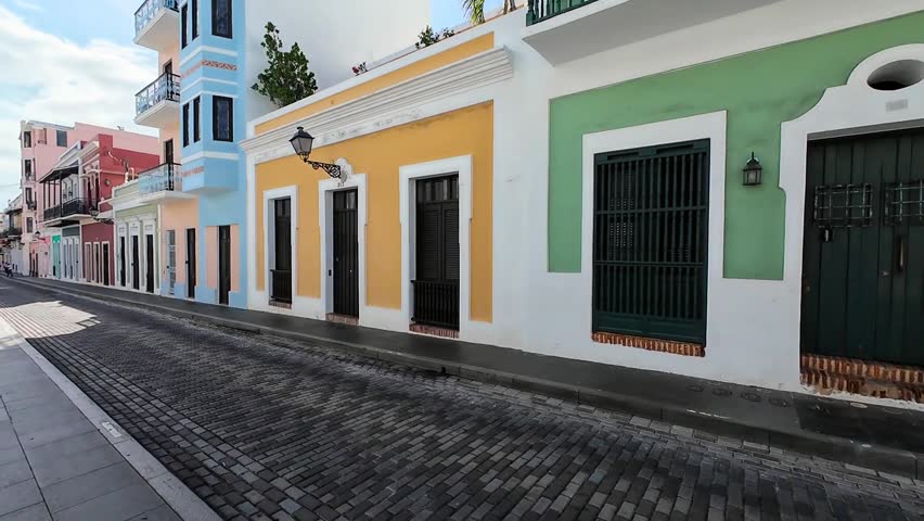 Walking video along side various colorful homes and buildings during sunset at Old San Juan, Puerto Rico