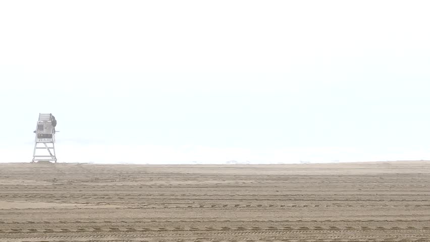 Trying to see the Atlantic Ocean through the fog with a life guard stand on the beach in Ocean Beach Maryland.