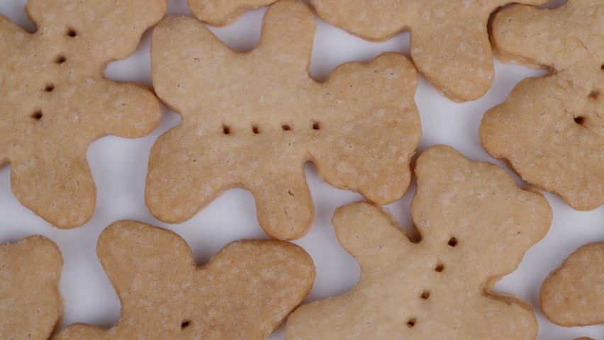 Golden shortbread bear pattern. Baked cookies with crumbly texture and features. Close up view showcasing textured shortbread cookies with detailed features and soft lighting