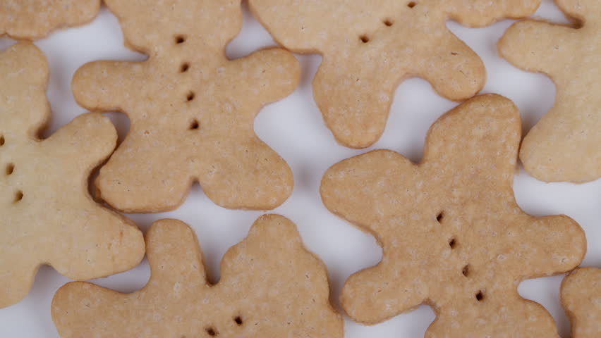 Homemade bearshaped cookies display. Cookies resembling bears scattered across surface. Softly lit closeup of homemade bear cookies with rustic charm and natural textures