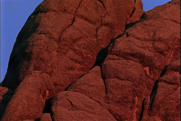 Pan across rocks and over faces carved in Mount Rushmore in Keystone, South Dakota.