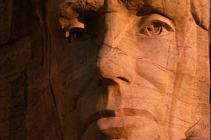 Pan across carved faces of the presidents in Keystone, South Dakota.
