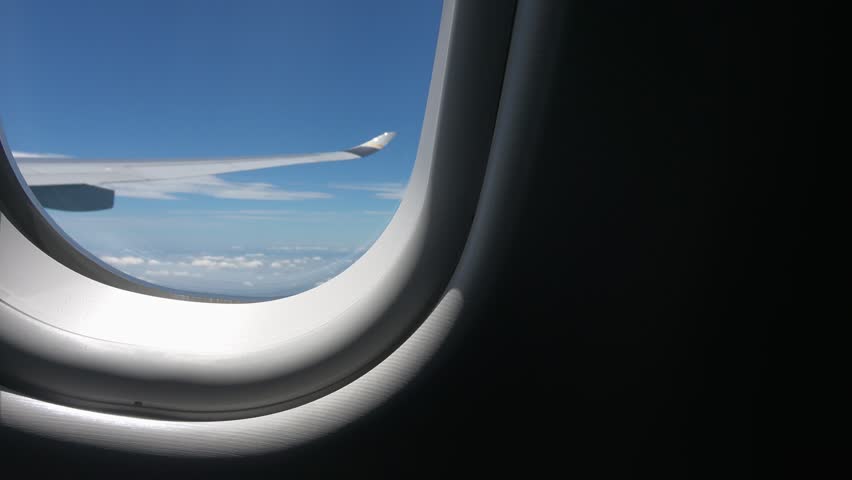 Cabin view: blue sky, white clouds, and sunshine outside.