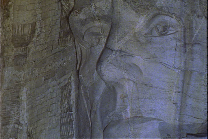 CU face of Abraham Lincoln illuminated at night in the Mount Rushmore National Memorial in Keystone, South Dakota.