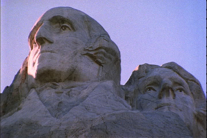 Low angle of sunlight hitting the faces of Washington and Jefferson in the Mount Rushmore National Memorial in Keystone, South Dakota.