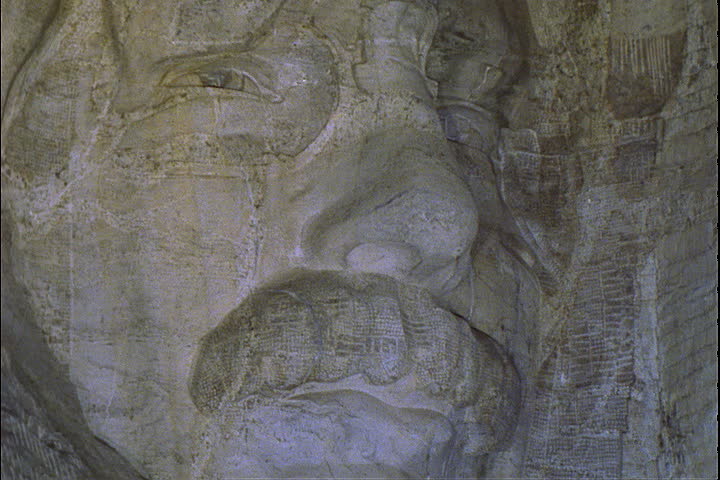 CU face of Theodore Roosevelt illuminated at night in the Mount Rushmore National Memorial in Keystone, South Dakota.
