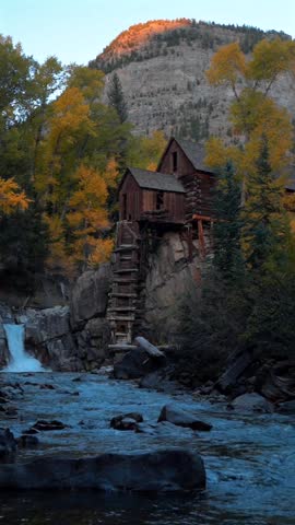 The Crystal Mill powerhouse silver mining rocky outcrop building lookout Crystal Marble Colorado fall Autumn shaded afternoon sunset Bear Mountain Crystal River vertical photographed scenic landscape