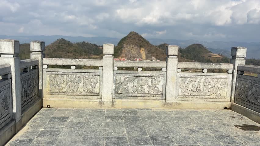 View from Lung Cu Flag Tower observation deck overlooking cultural center, staircase and mountain landscape in Ha Giang Vietnam
