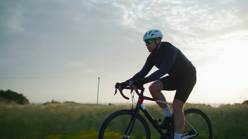Cyclist riding a bike in a beautiful nature landscape. sport cycling training, cardio workout and healthy lifestyle.
