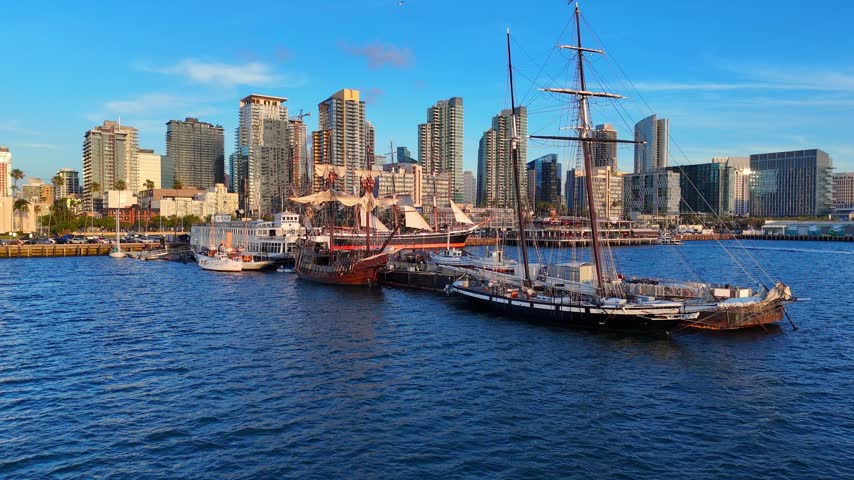 San Diego bay with financial district on city skyline in aerial ascending view on sunny evening