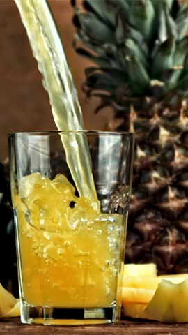 Pineapple juice is poured into a glass. Filmed is slow motion 1000 fps. High quality FullHD footage