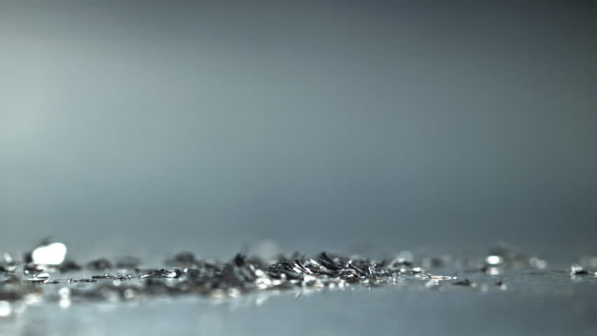 Closeup spiral drill flute carving metal, chips and flakes scattering, Filmed on a high-speed camera at 1000 fps.