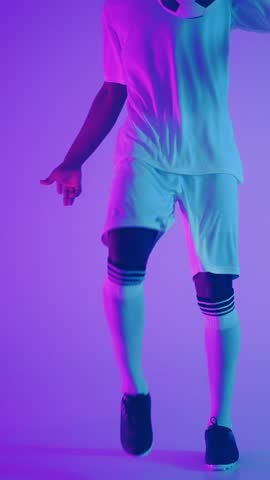 Dynamic portrait and action shot of a male football player in white uniform, illuminated by vibrant purple and blue lighting, showcasing athleticism and intensity in sports.