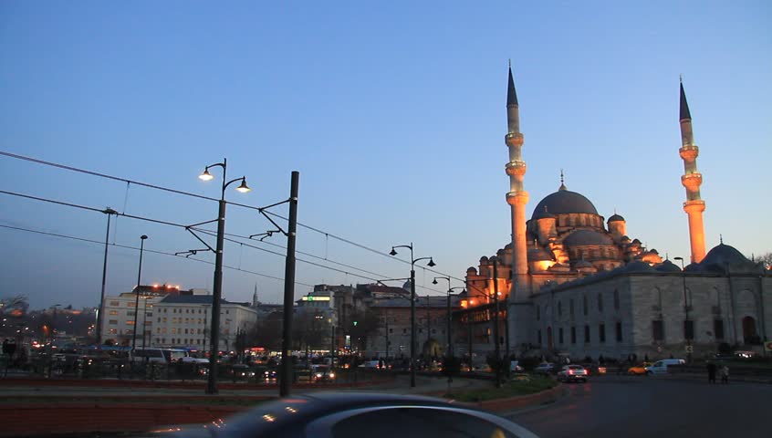ISTANBUL - FEB 11: Yeni Mosque calls Muslims for evening pray at Eminonu Square