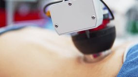 Closeup of a man receiving back massage from robotic device. Advanced AI powered machine performs precise therapy movements on skin combining wellness and cutting edge technology. Automation in health - Powered by Shutterstock - Get 15% off with code: PIKWIZARD15
