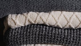 Stack of knitted sweaters for cold weather, moving shot. - Powered by Shutterstock - Get 15% off with code: PIKWIZARD15
