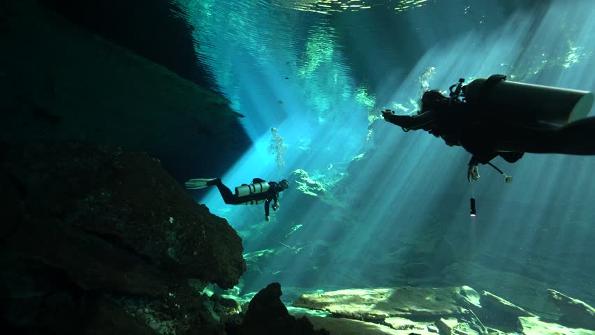 Scuba Diver Gliding Through Crystal Clear Cenote Waters