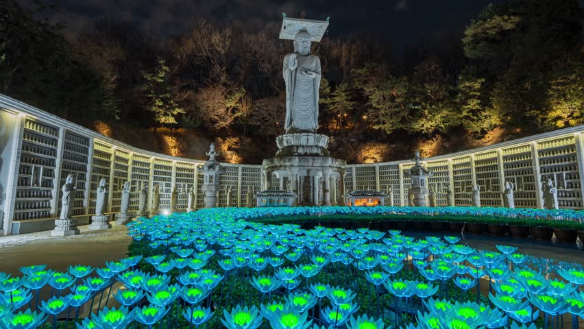 Bongunsa Temple in Seoul, South Korea, at night is striking with its illuminated lotus lanterns and large standing Buddha statue, creating a serene and spiritual atmosphere.Time lapse video zoom out.