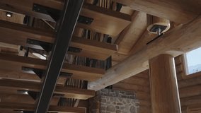 Interior architectural details of a rustic log cabin with exposed wooden beams and staircase - Powered by Shutterstock - Get 15% off with code: PIKWIZARD15