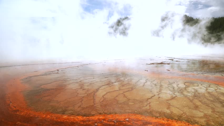 Grand Prismatic Spring vibrant colorful hot springs dense steam pool Midway Boardwalk Fairy Falls trail Mid Geyser Basin Wyoming USA Yellowstone National Park nature landscape sunny morning blue sky