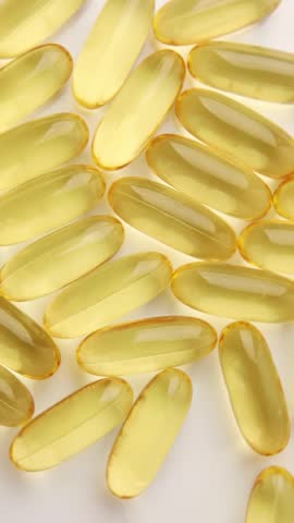 Rotation Closeup fish oil capsules Omega 3 isolated on white background, Health care concept, macro.
