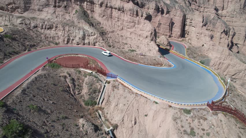 Aerial Shot of the Yellow River Stone Forest Scenic Area and the Twenty-Two Hairpin Bends

Located in Jingtai County, Baiyin City, Gansu, the Yellow River Stone Forest is a national AAAA scenic area and geopark spanning about 50 km². Formed over 4 million years from yellow sandstone and conglomerate, its towering pillars (up to 200 m high) were sculpted by crustal shifts, wind, and water erosion. Nestled beside the winding Yellow River, it features dramatic canyons like Yinma Valley, the iconic Twenty-Two Hairpin Bends, and lush Longwan Oasis. A filming spot for many movies, it blends raw natural grandeur with unique northwest China charm.