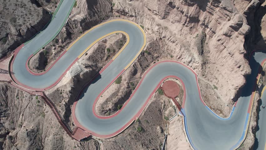 Aerial Shot of the Yellow River Stone Forest Scenic Area and the Twenty-Two Hairpin Bends

Located in Jingtai County, Baiyin City, Gansu, the Yellow River Stone Forest is a national AAAA scenic area and geopark spanning about 50 km². Formed over 4 million years from yellow sandstone and conglomerate, its towering pillars (up to 200 m high) were sculpted by crustal shifts, wind, and water erosion. Nestled beside the winding Yellow River, it features dramatic canyons like Yinma Valley, the iconic Twenty-Two Hairpin Bends, and lush Longwan Oasis. A filming spot for many movies, it blends raw natural grandeur with unique northwest China charm.