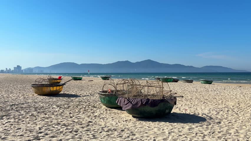 Video of traditional Vietnamese fishing boats resting on the beach in Vietnam. Coastal scene with local maritime culture, representing fishing industry, travel and Southeast Asian lifestyle.