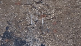 Urban wet textures. Closeup of rainy city pavement. Detailed shot of wet asphalt in city environment. Macro view highlighting rain effects on city pavement surface - Powered by Shutterstock - Get 15% off with code: PIKWIZARD15