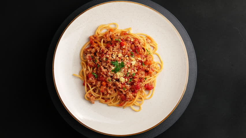 Spaghetti with minced pork in tomato sauce, pasta with a meat based bolognese tomatoes in white plate.Top view.