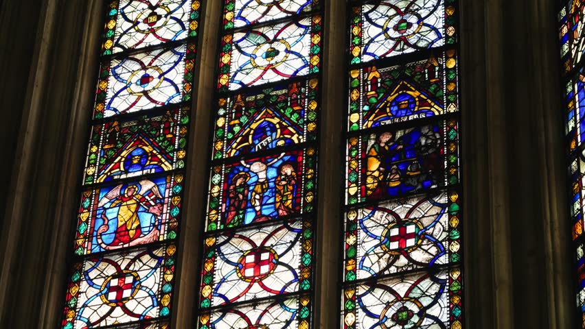 Beautiful stained glass windows inside a Catholic cathedral. Sacred architecture and colorful religious art. High quality 4k footage