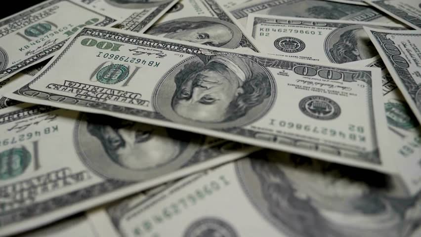 A pile of american dollar paper money at table. Cash dollar money banknotes. Finance and investment concept. Pile of american dollar bills. The concept of earnings and business profitability.