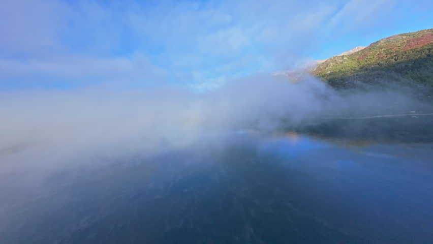 FPV Drone Gliding Over Dense White Clouds and Mountains