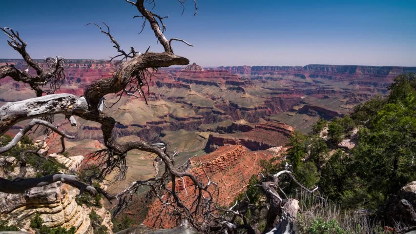 AERIAL Grand Canyon, USA with amazing lighting, clouds, red cliffs and blue skies in 4K DCI. View over the sunny a red rock of mountain Zion
